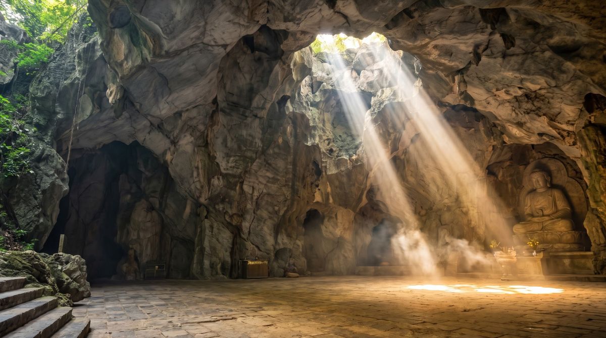 Beams of sunlight crossing the Buddha shrine in Huyen Khong cave